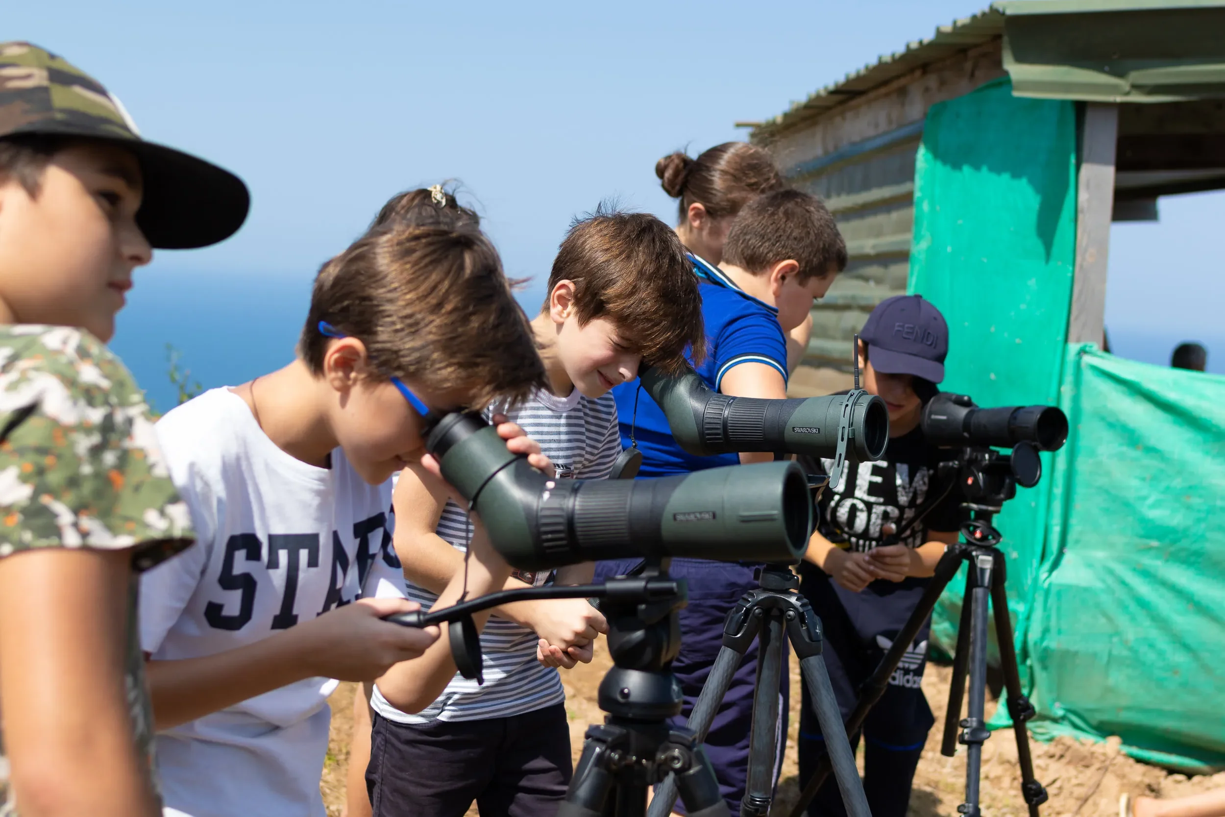 Children from local schools visit the stations and have their first peeks through binoculars and scopes