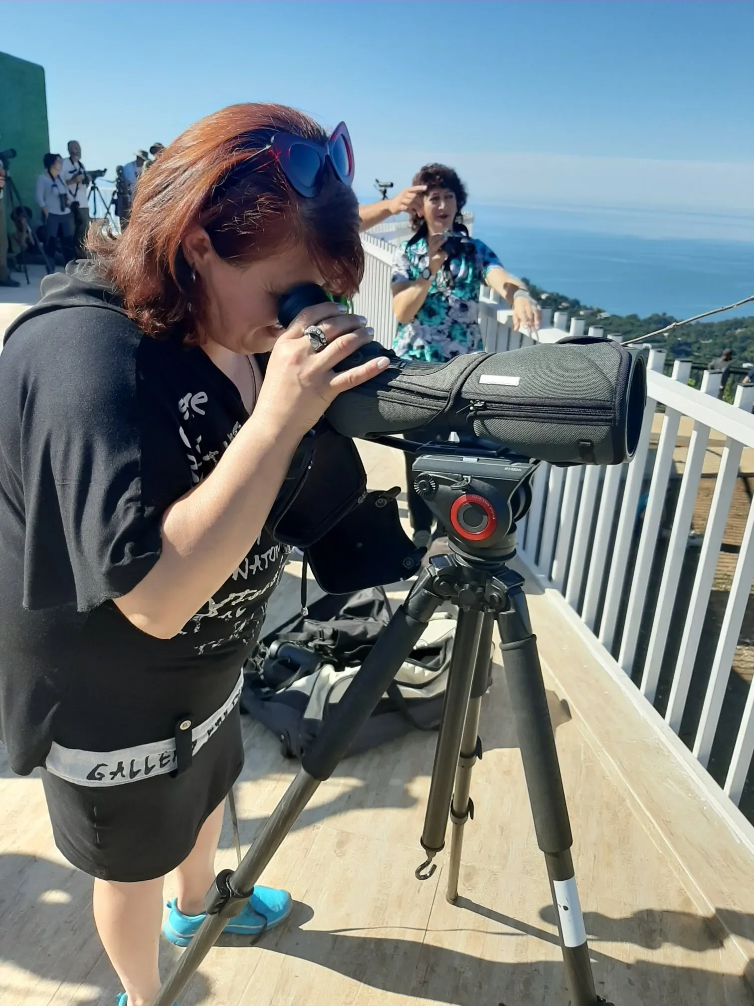 A visitor taking a peek through the scopes on station