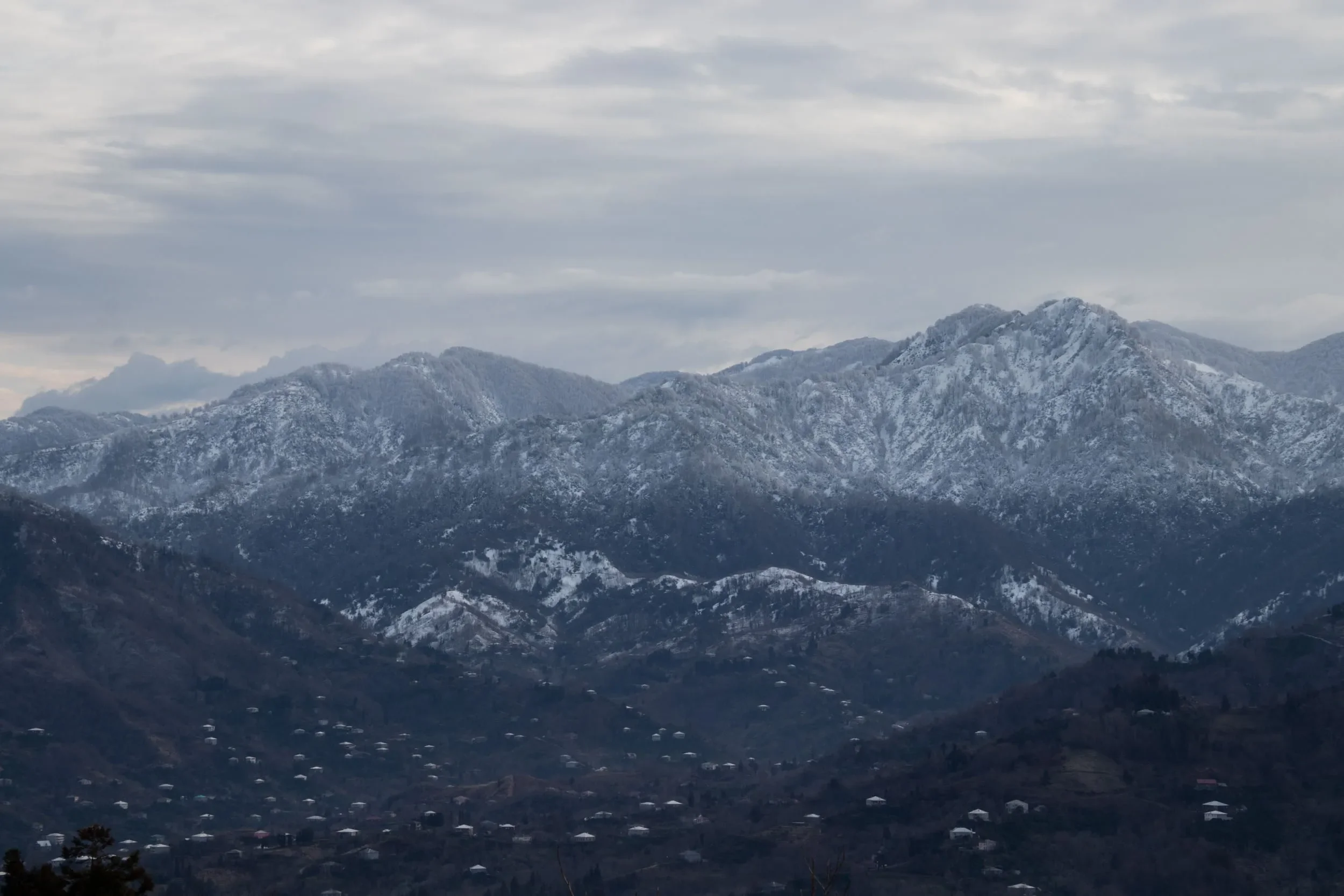The snow-covered mountains behind the count station